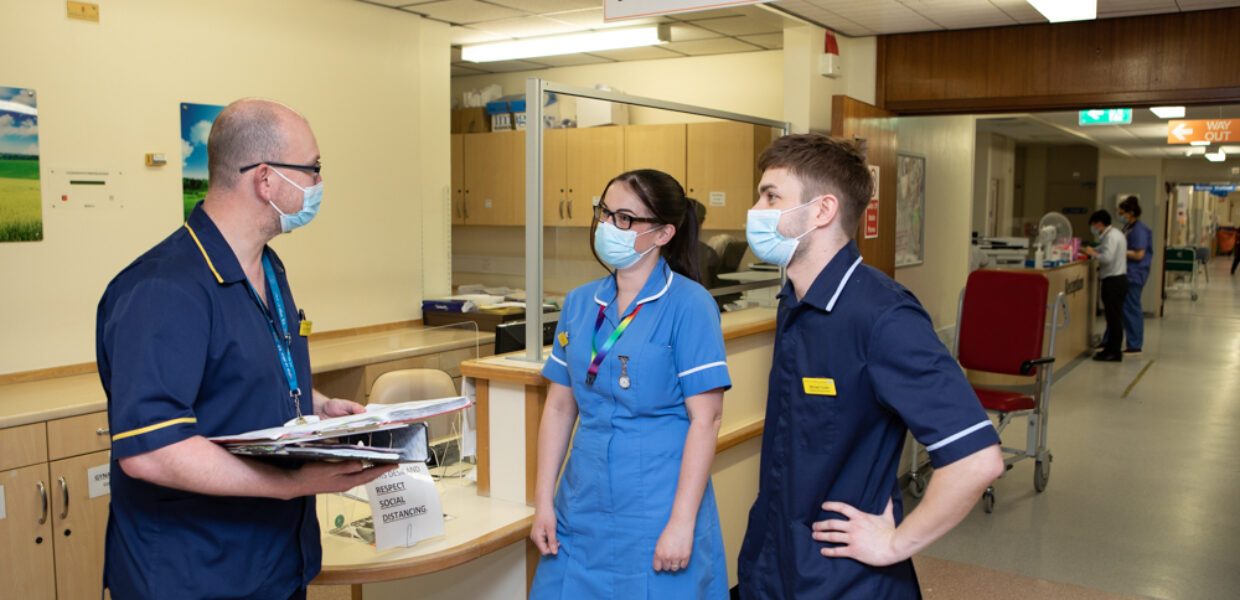 Clinical staff in conversation at Grimsby Hospital