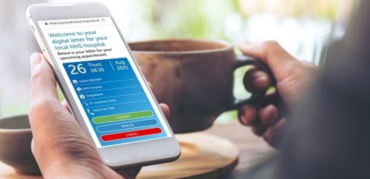 holding a phone in one hand, mug in the other