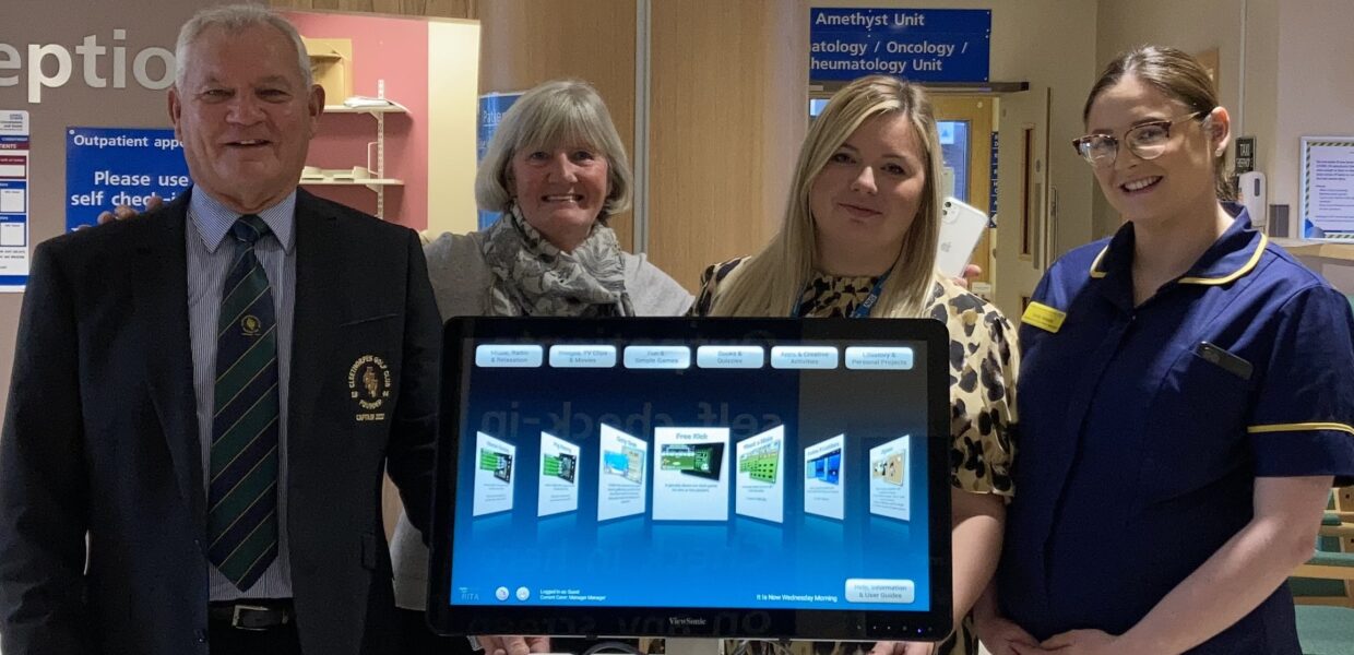 Members of Cleethorpes Golf Club and staff from The Health Tree Foundation and the Trust stood with a RITA machine in a hospital reception.